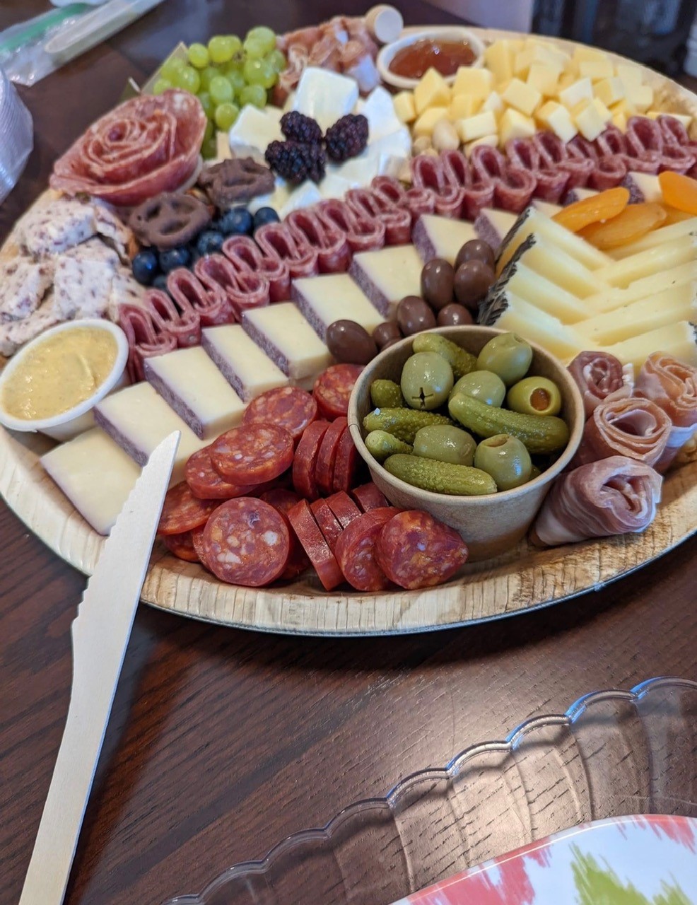 Artisan charcuterie board with brie, berries, salami, and accompaniments