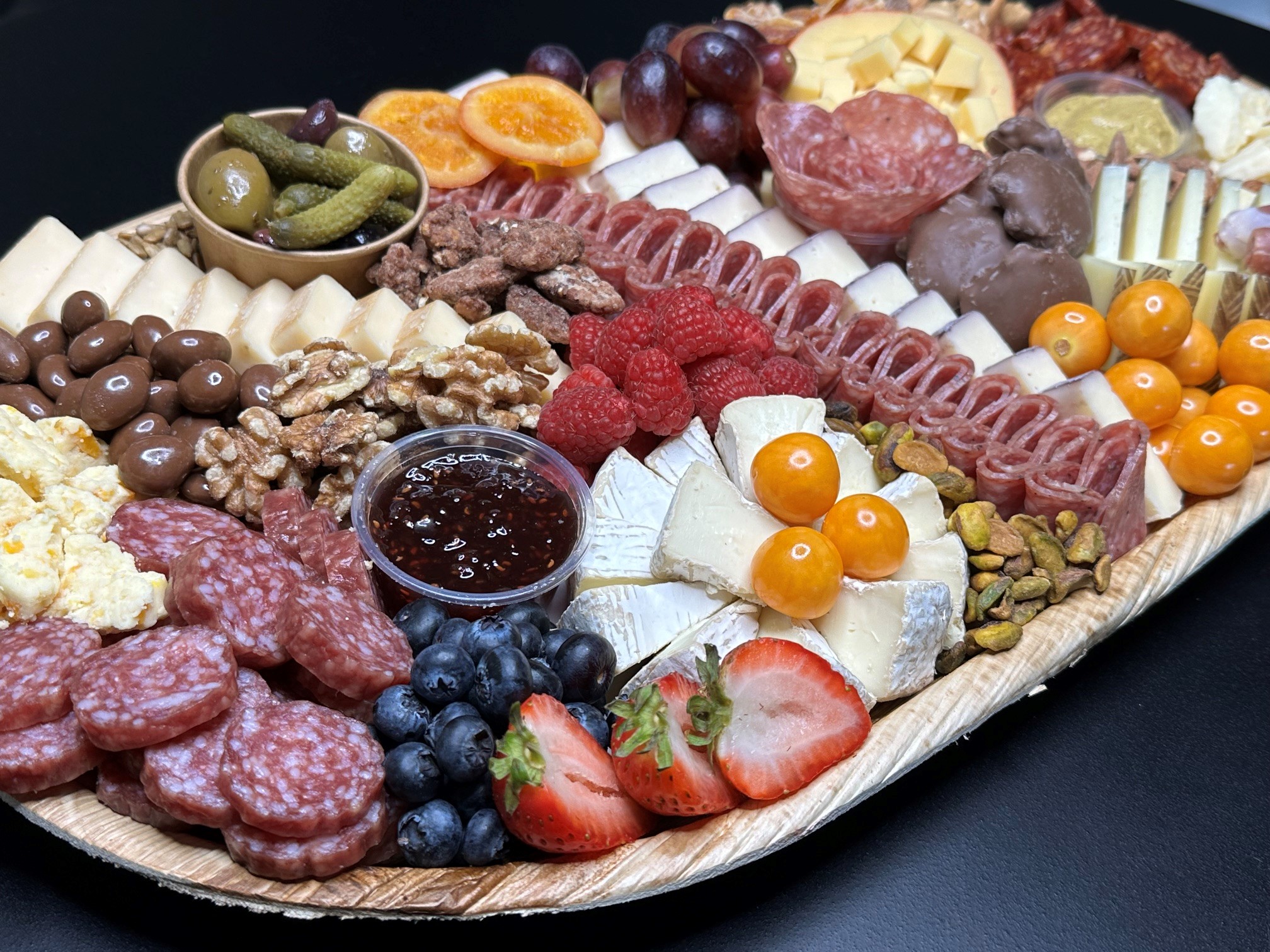 Handcrafted board with chocolate, dried fruits, nuts, and cured meats