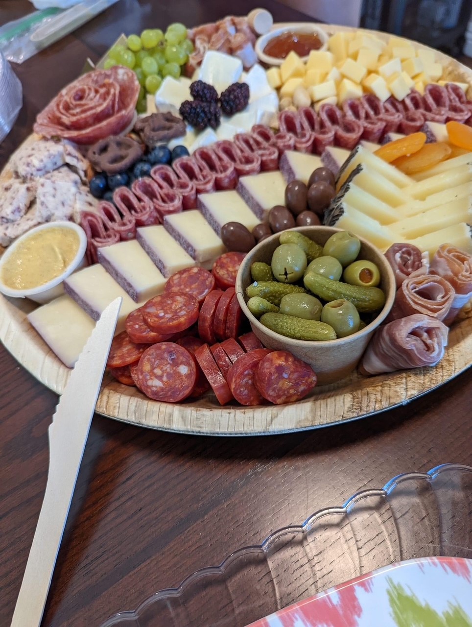 Charcuterie selection with berries, brie, golden berries, and walnuts